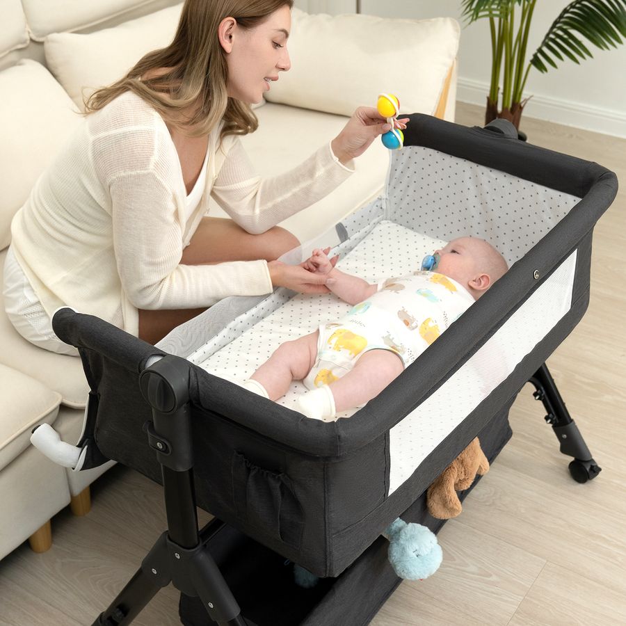 Mother playing with her baby in a BCOL bedside sleeper